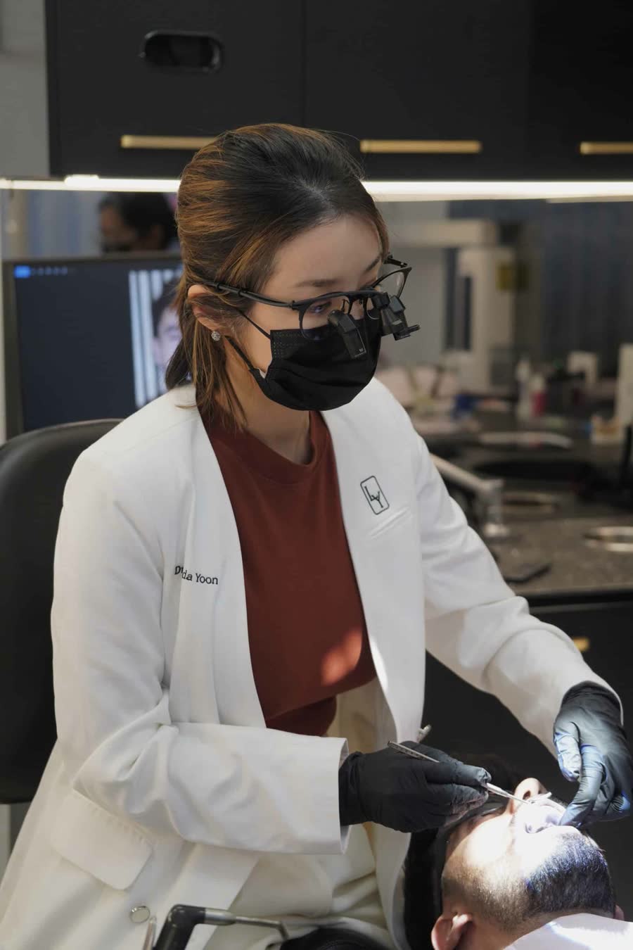 A Lumina clinician in magnifying loupes at work