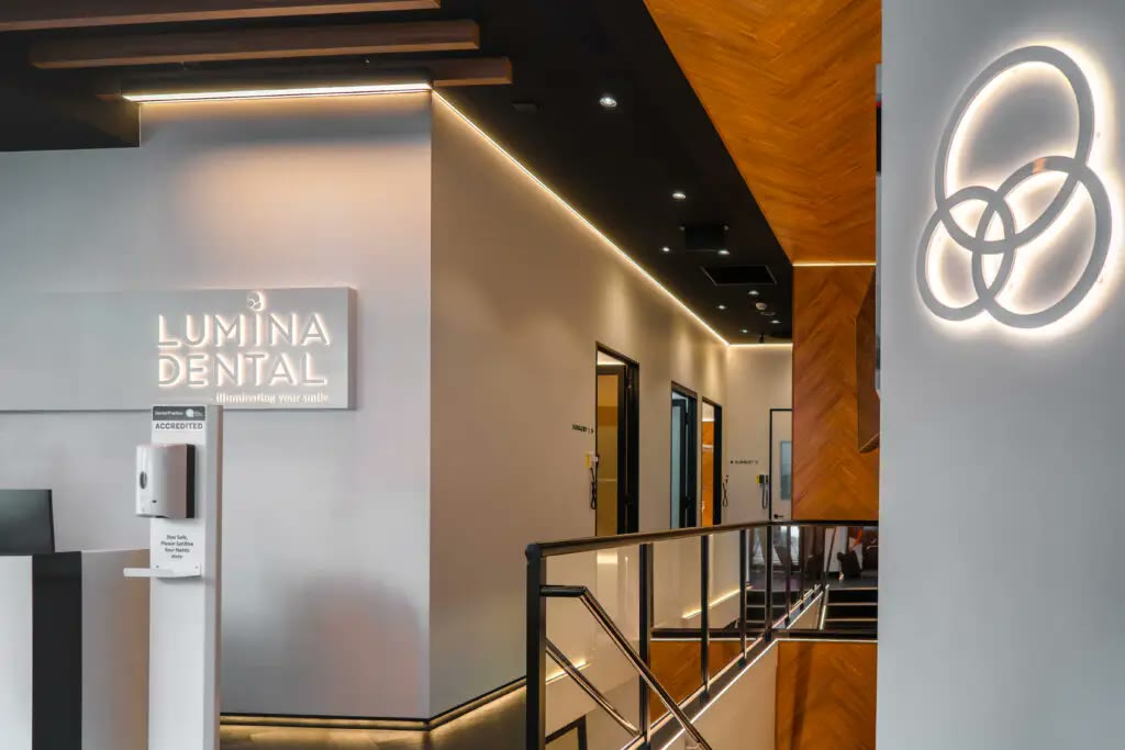 The Lumina Dental lobby — illuminated signage under a timber ceiling